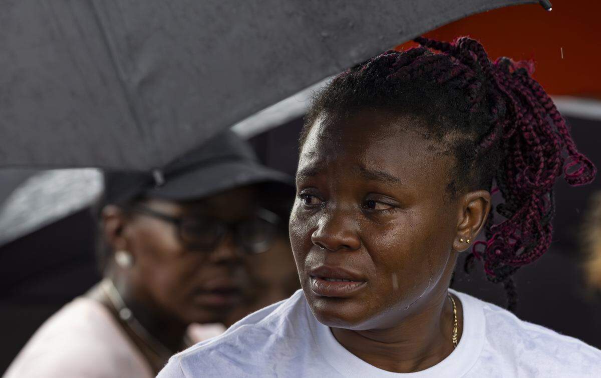 Lateisha Wilkinson cries as she visits a makeshift memorial for her mother, Doreen Richards Broadbelt, 71, who police said was walking to her job at Walmart when a dog attacked and fatally mauled her near her home on Labor Day. A vigil was held nearby at Broadbelt's home on Tuesday, Sept. 9, 2025, in Miami Gardens, Fla.