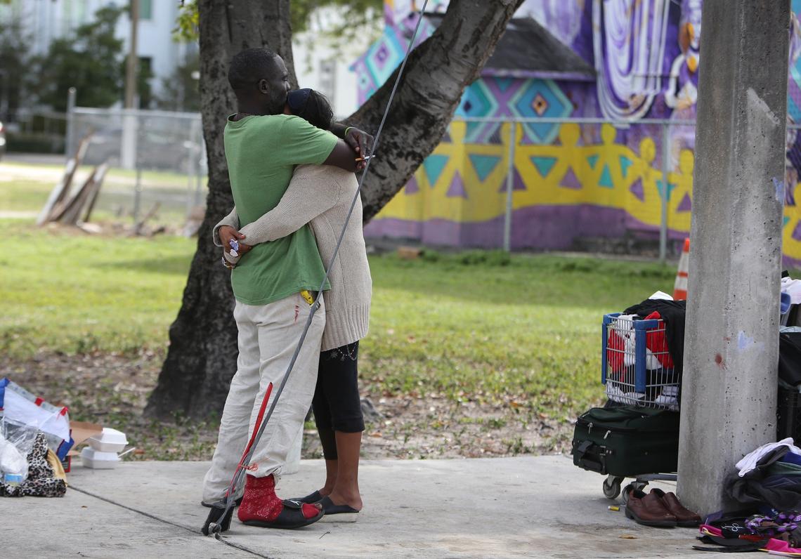 Philip Sylverin and his girlfriend, Laurie, hug on the Overtown corner where they spend much of their time. Both are homeless and struggle with drug addiction, but have benefited from Miami’s IDEA Needle Exchange.