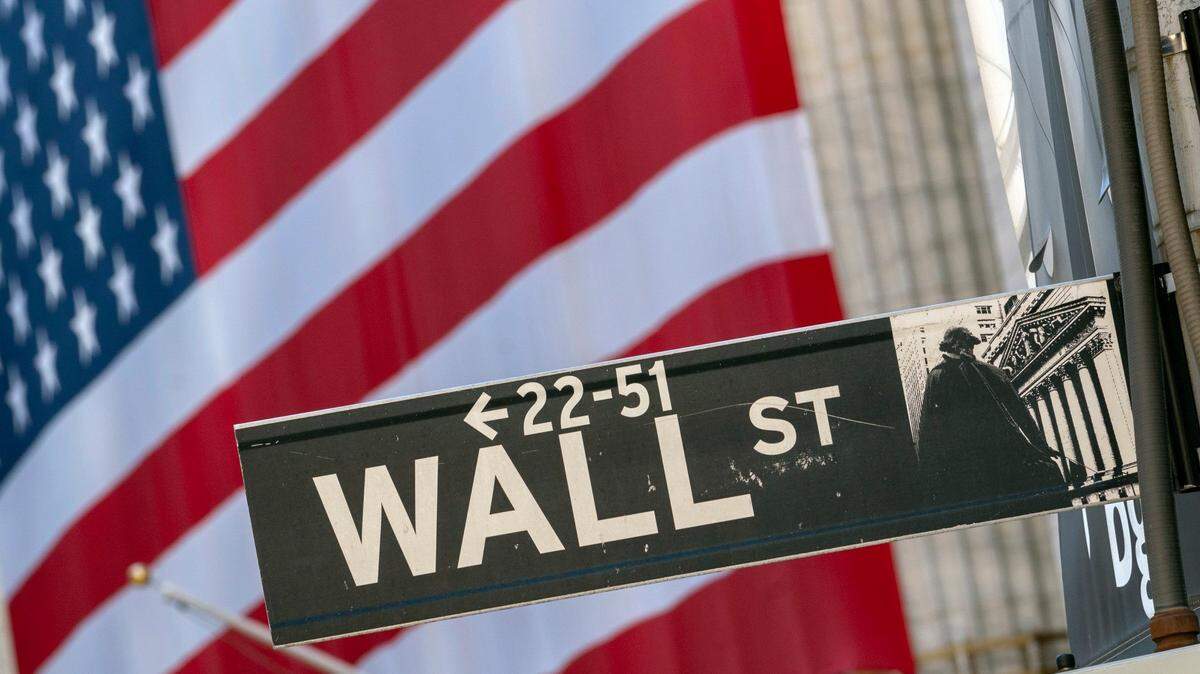A Wall Street sign hangs in New York near the New York Stock Exchange.