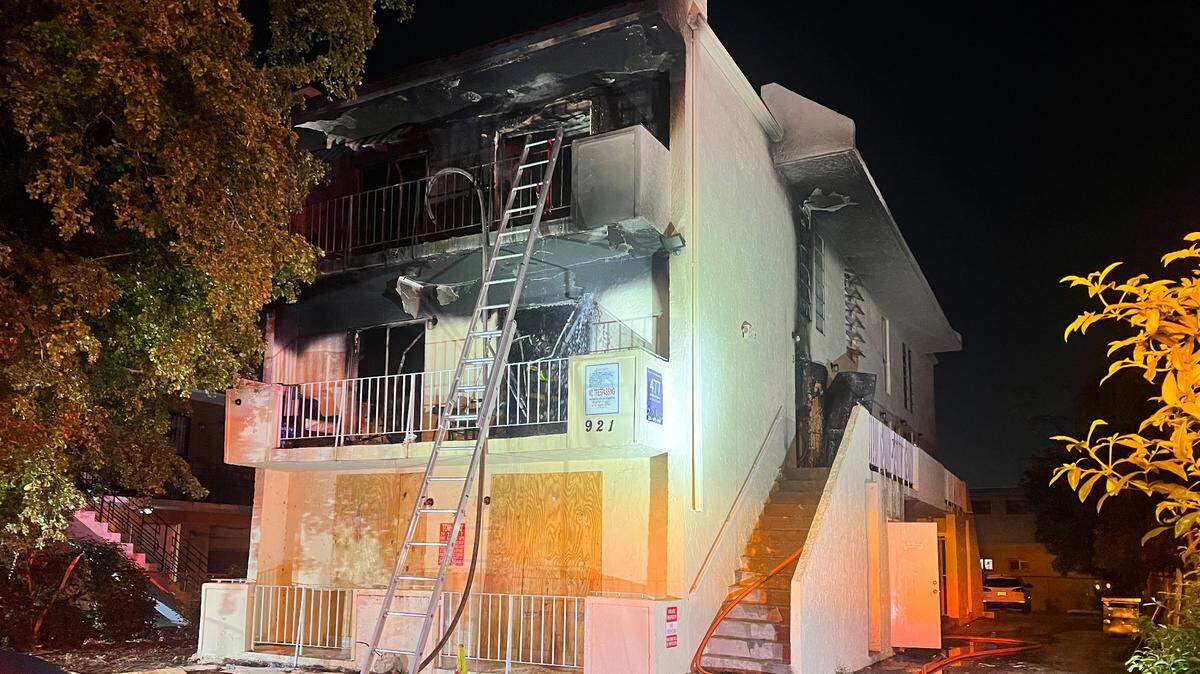Miami firefighters rescued over a dozen people, including a child, from a three-story apartment complex that caught fire, officials said.