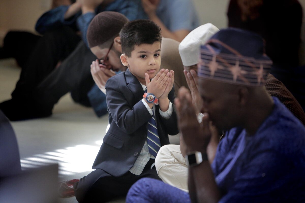 Five year old Asmir Butt prays along with other members of the Baitul Naseer Mosque in Hallandale Beach, Fl.