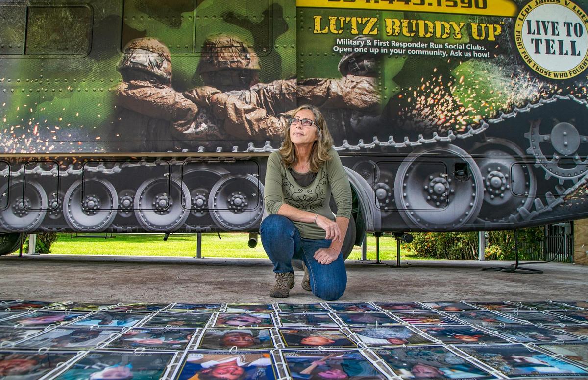 Janine Lutz talks about her nonprofit in front of the RV in which she travels around the country.