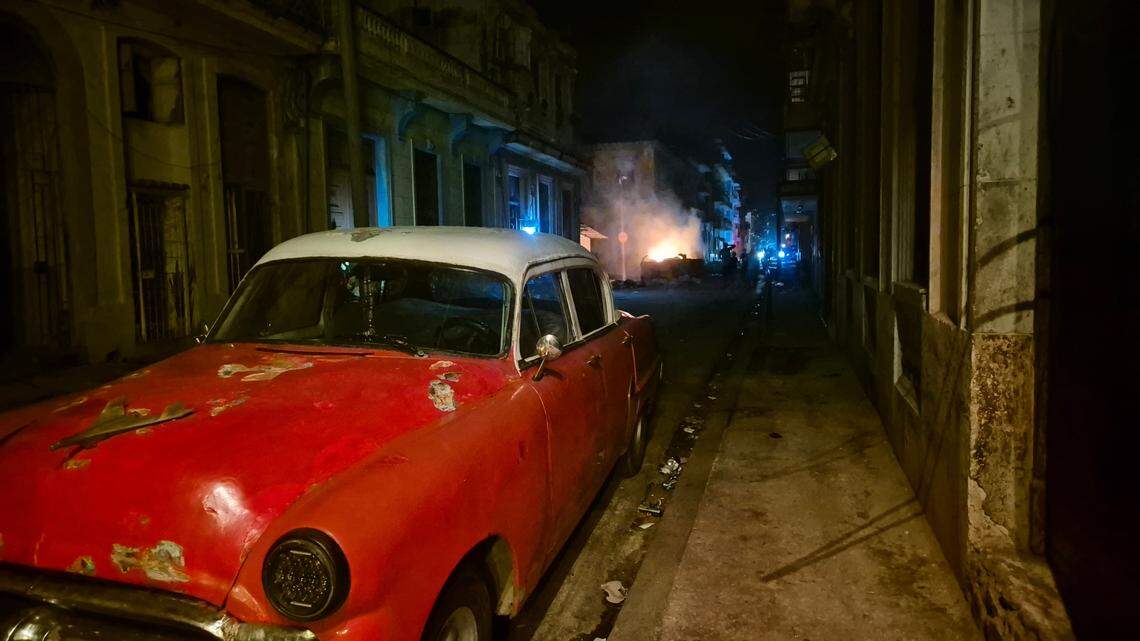 During an island-wide power outage in Cuba on Oct. 20, an old car in Havana is parked near a burning garbage can.