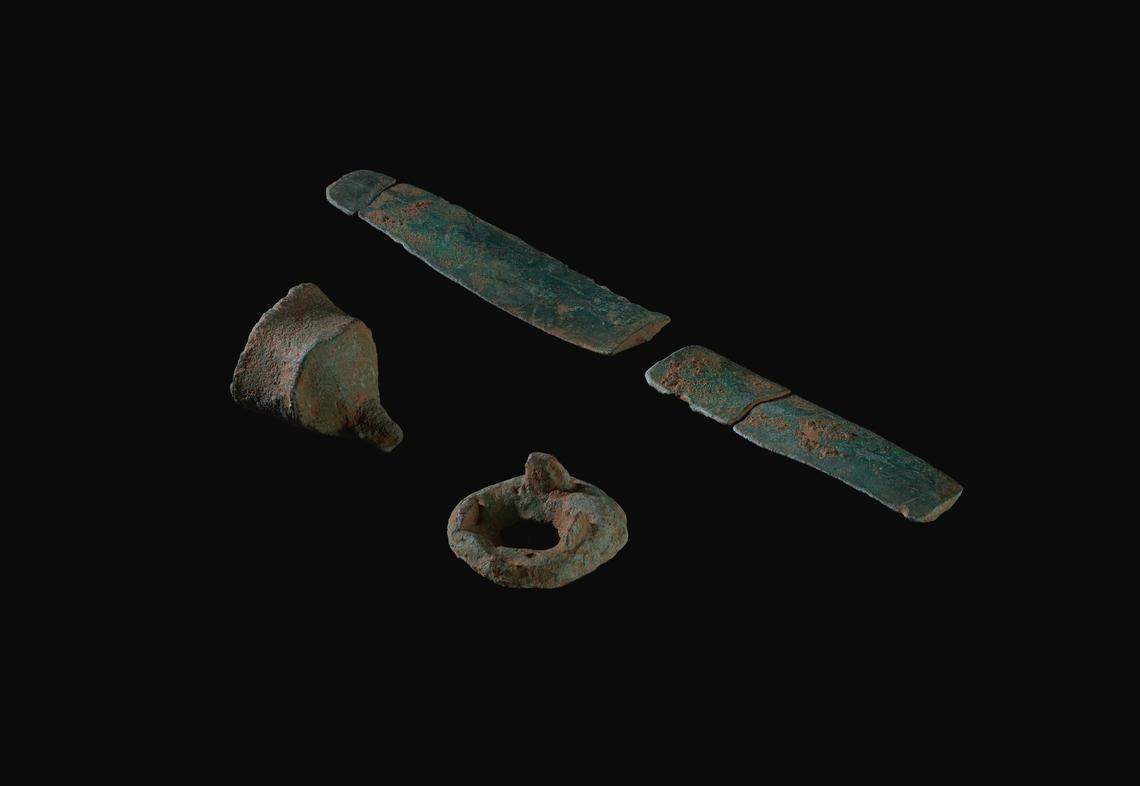 The fragmented sword and other metal artifacts found in the field.