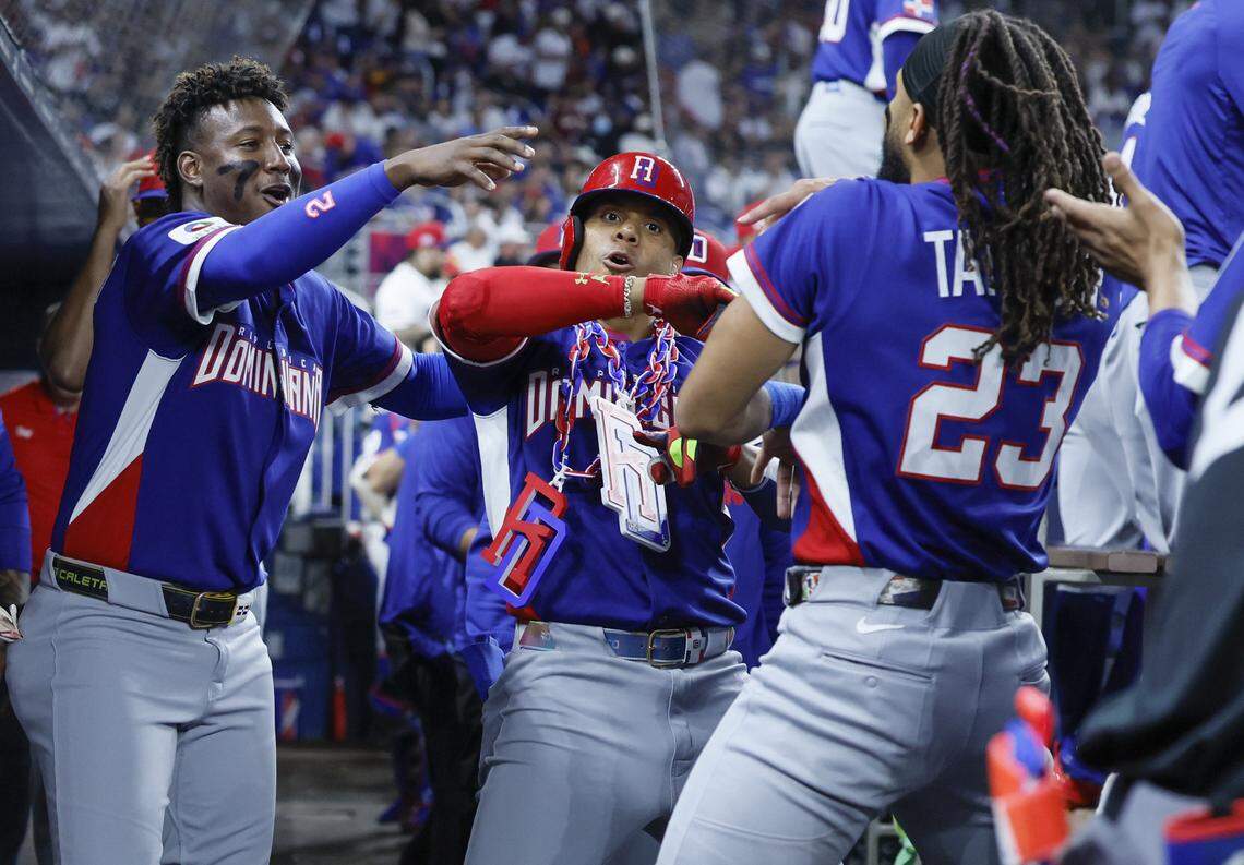 Dominican Republic right fielder Juan Soto (22), seen at center, celebrates in the dugout with teammates after scoring a homerun against Venezuela in the third inning during the World Baseball Classic at loanDept park on Wednesday, March 11, 2026.