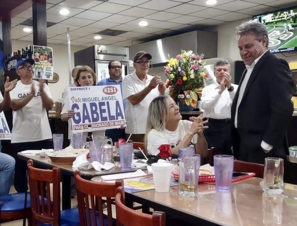 Miguel Angel Gabela, far right, celebrates the results of the city of Miami elections on Tuesday, Nov. 7, 2023, at El Caribe Restaurant in Allapattah. Gabela will face incumbent Alex Diaz de la Portilla in the Nov. 21 runoff election.