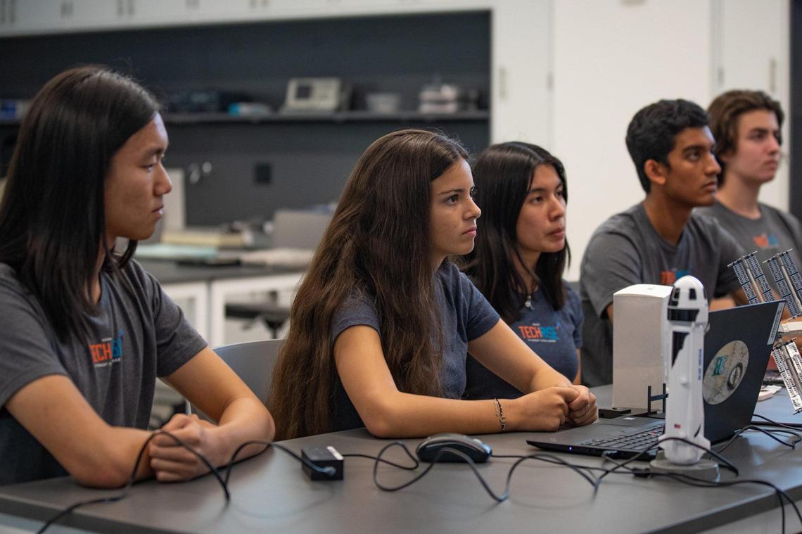 Ransom Everglades School seniors (L-R) Theodore Ma, Sofia Paraoulaki de Miranda, Dadly Leon, Arjun Badwal, and Adrian Stone Perez discuss with a NASA scientist before testing their rocket payload in advance of an actual launch into space on a Blue Origin’s New Shepard rocket with a simulation on Friday, Sept., 18, 2022.