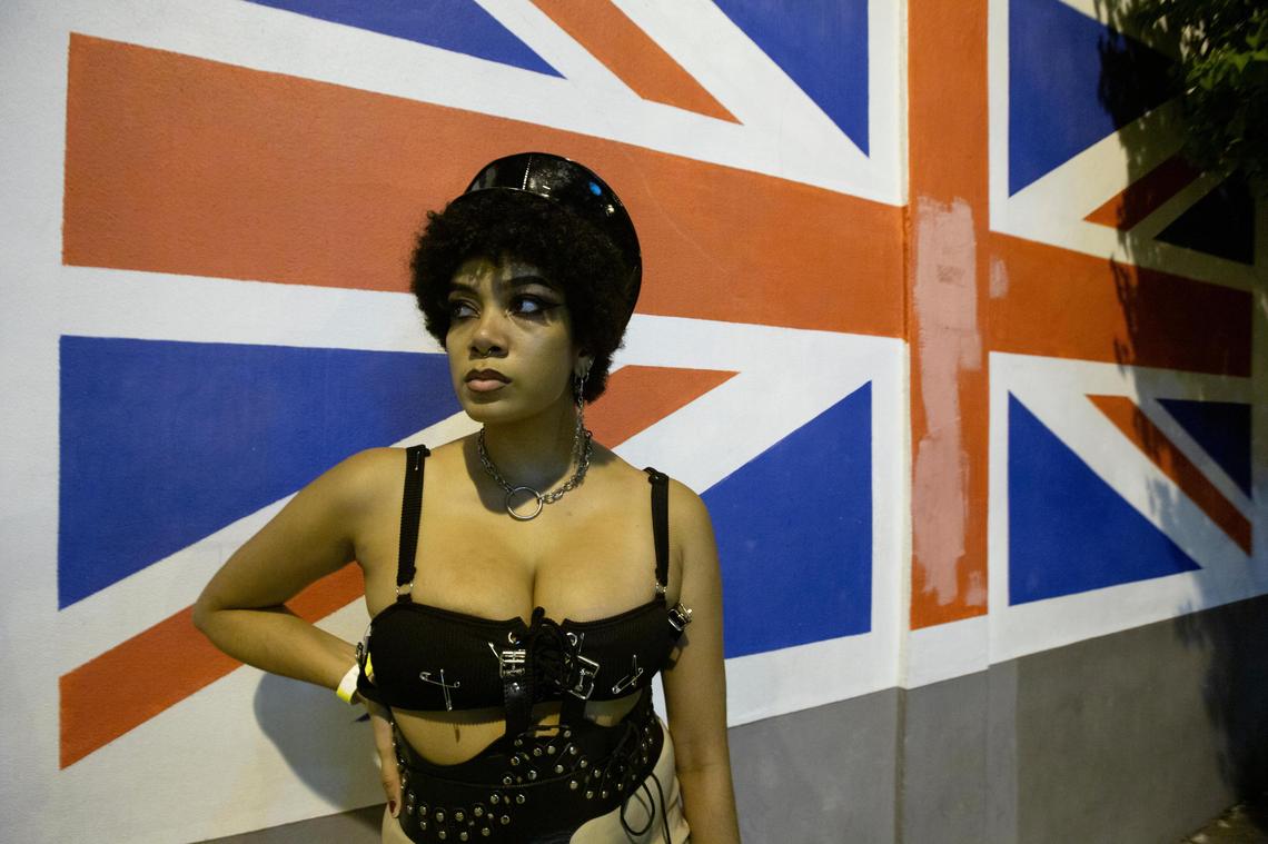 Marceline Steelp stands in front of a British flag at Churchill’s Pub in 2019.