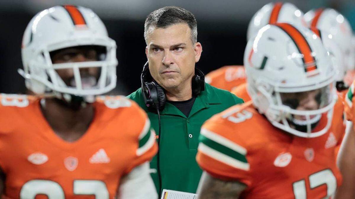 Miami head coach Mario Cristobal walks with players during a timeout against Florida State at Hard Rock Stadium on Nov. 5, 2022, in Miami Gardens, Florida. (Al Diaz/Miami Herald/TNS)