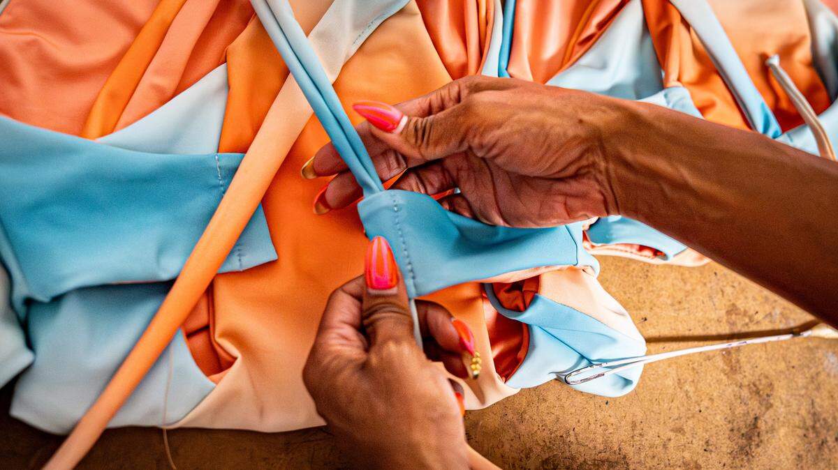 Keva Johnson, a swimsuit designer from Miramar, threads straps through a swimsuit in her head seamstress's studio on Wednesday, May 27, 2026, in Miami, Florida.