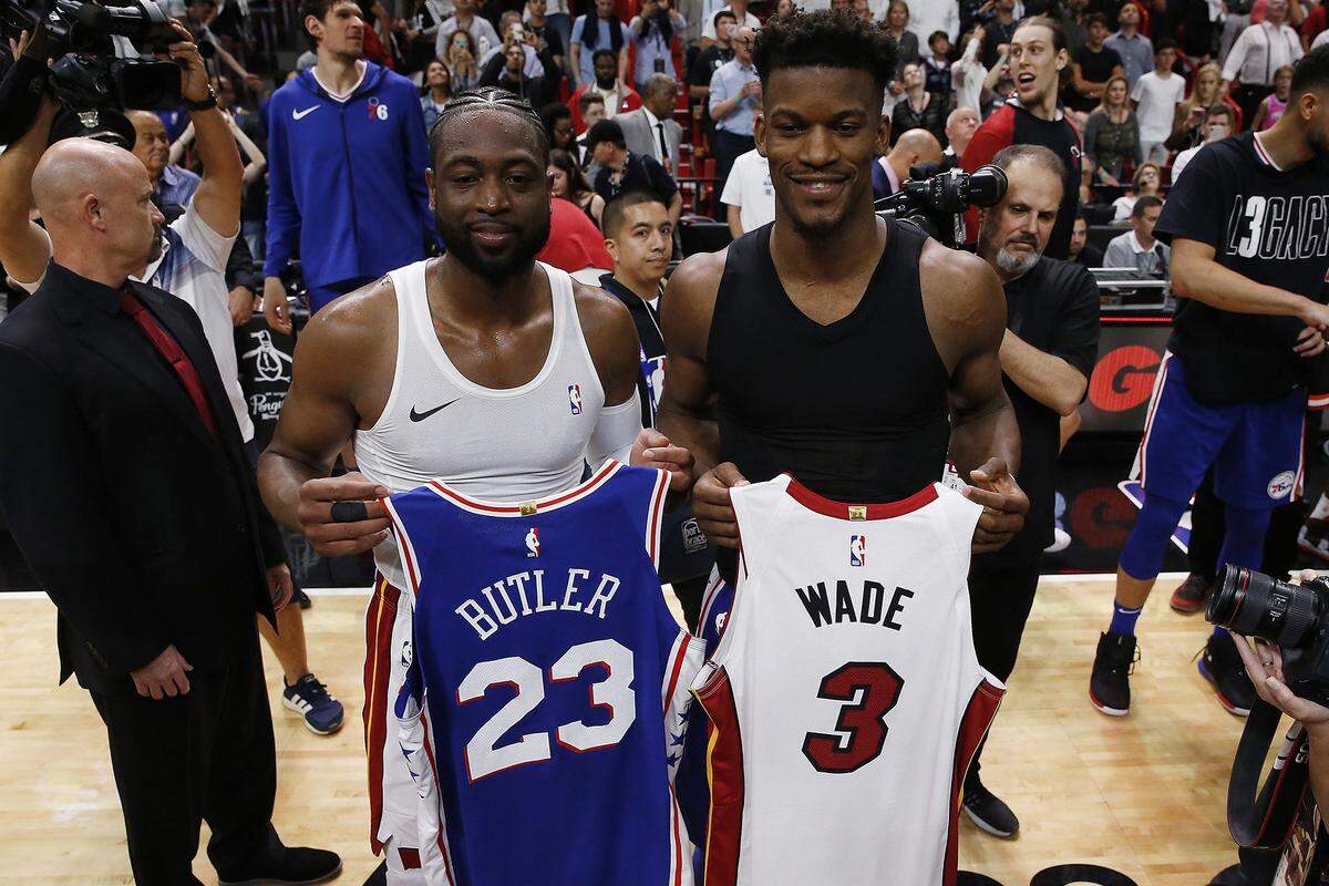Dwyane Wade of the Miami Heat exchanges jerseys with Jimmy Butler of the Philadelphia 76ers after a game at American Airlines Arena in Miami on April 9, 2019. Wade has since retired, and Butler reportedly is now being traded to the Heat.
