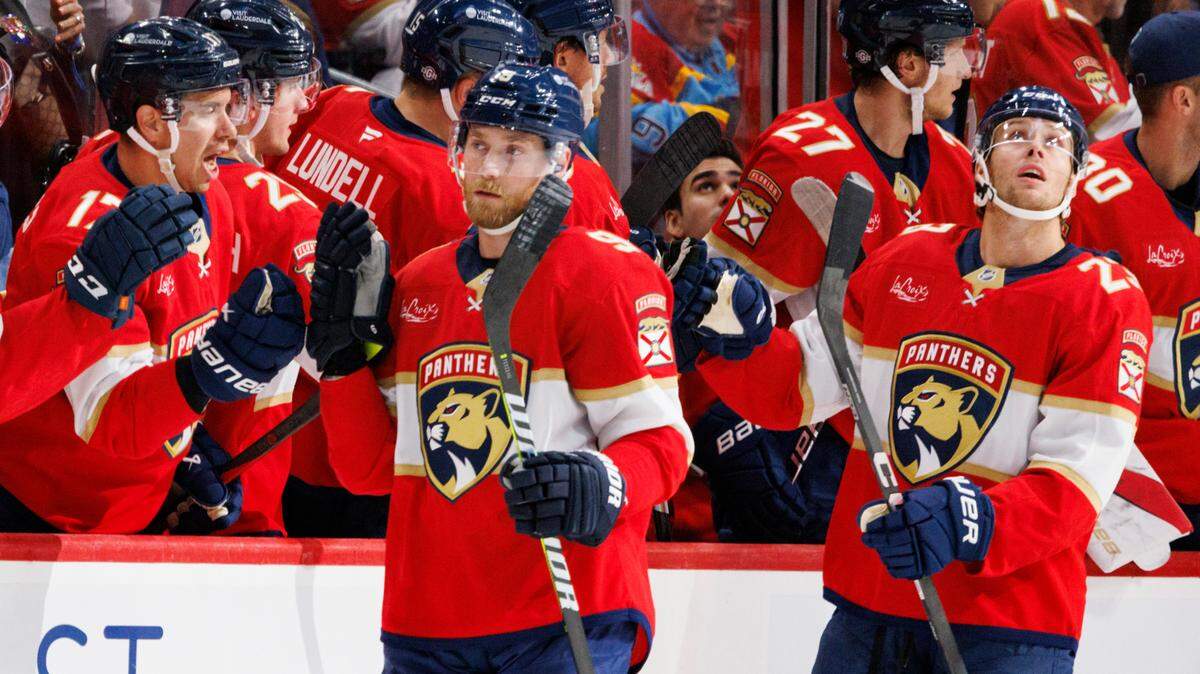 Florida Panthers center Sam Bennett (9) high fives teammates after scoring a goal during the second period of a game on Tuesday, Oct. 22, 2024, at Amerant Bank Arena in Sunrise, Fla.