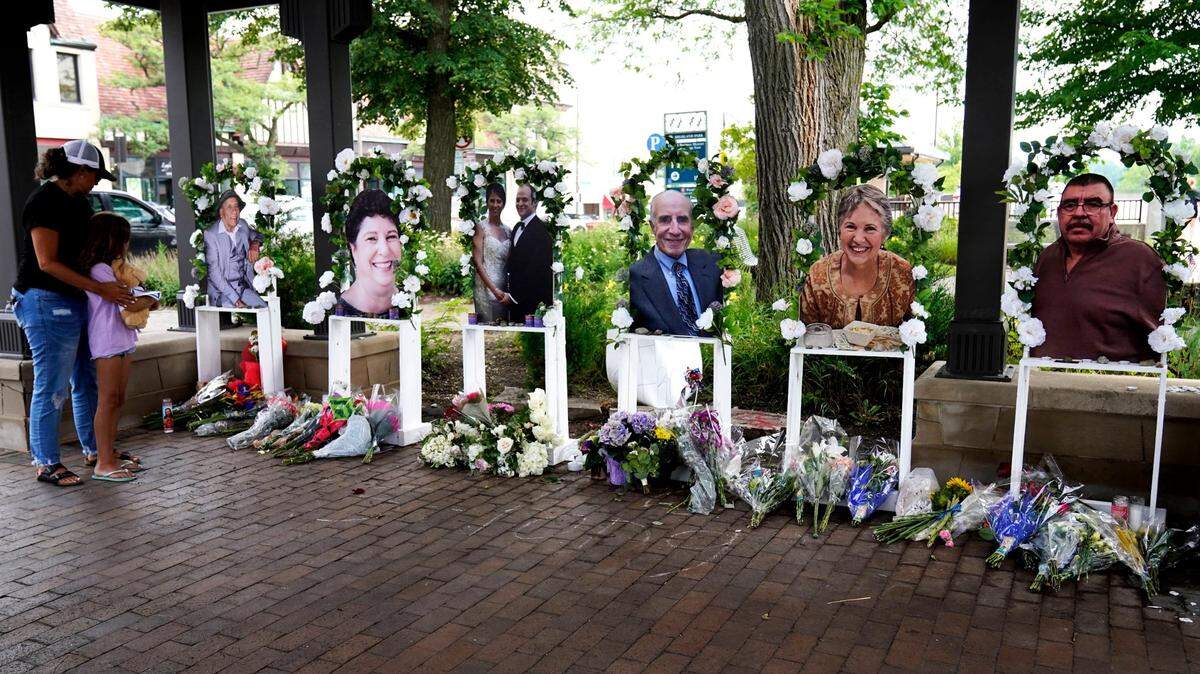 Visitors pay their respects at altars for the seven people killed in Monday’s Fourth of July mass shooting, Thursday, July 7, 2022, in Highland Park, Ill.