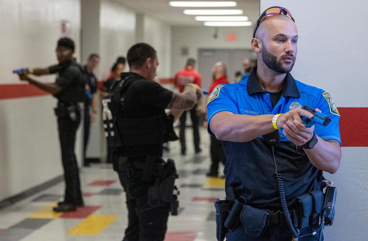 Miami-Dade Schools Police officers secure the hallway during an active shooter drill held at Coral Gables Senior High School on Friday, July 15, 2022.