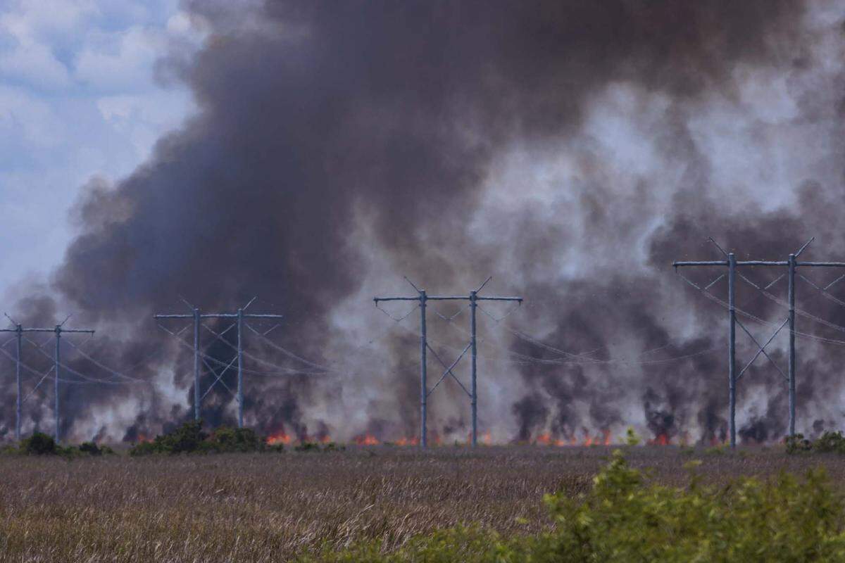 A wildfire burns west of Weston into the Everglades on Monday, May 11, 2026, seen from Everglades Holiday Park in Fort Lauderdale, Fla. 