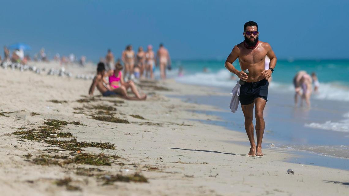 Gus Martinez, 37, jogs toward South Pointe Park Pier in Miami Beach, Florida on Monday, February 15, 2021.