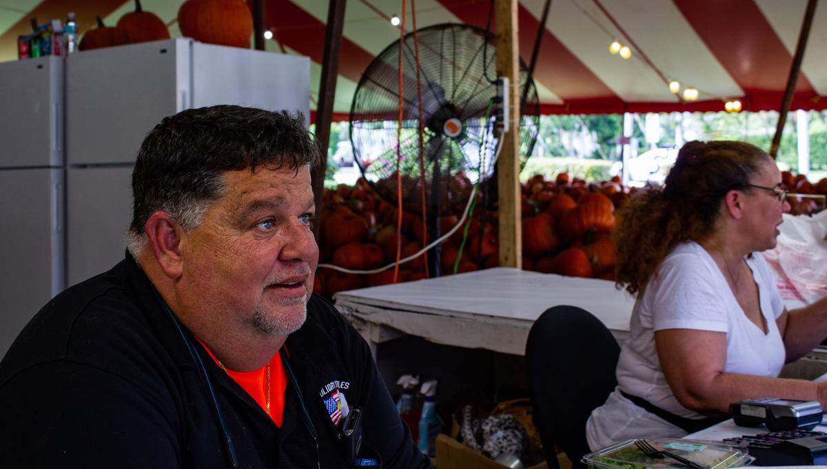Chris Winkler, owner of The Pumpkin Patch in Kendall, and his wife Rosie ring up sales of Halloween pumpkins. The Winkler family has been operating the pumpkin patch, at Southwest 82nd Avenue and 104th Street, for 50 years.