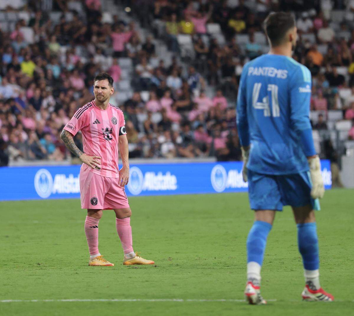 Inter Miami CF forward Lionel Messi (10), left, looks towards the Northside of stadium where Inter Miami fans (La Familia) chant their displeasure with the players over the lack of engagement between players and fans as Inter Miami wins its first home game against the Portland Timbers at the Nu Stadium on Sunday, May 17, 2026, in Miami, Florida.