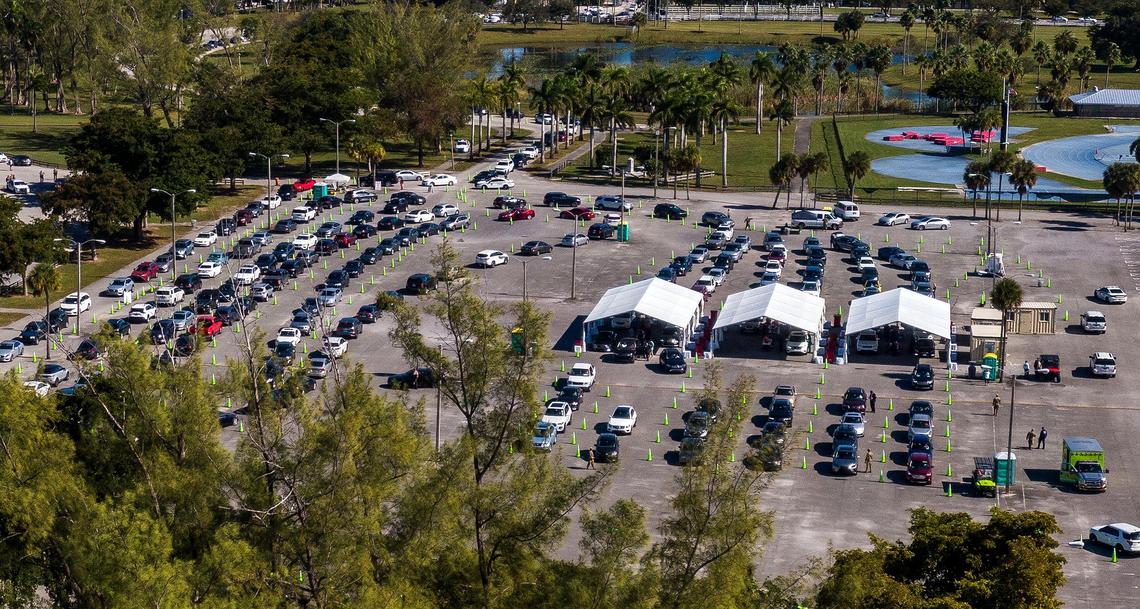 Long lines of cars wait as people with appointments get the COVID vaccine at Tropical Park test site on Saturday, Jan. 9, 2021. The Florida Highway Patrol and Miami-Dade Police urged drivers to avoid a portion of Bird Road because large crowds hoping to get the COVID-19 vaccine at the park led to traffic jams. Coronavirus numbers are surging in Miami-Dade County.