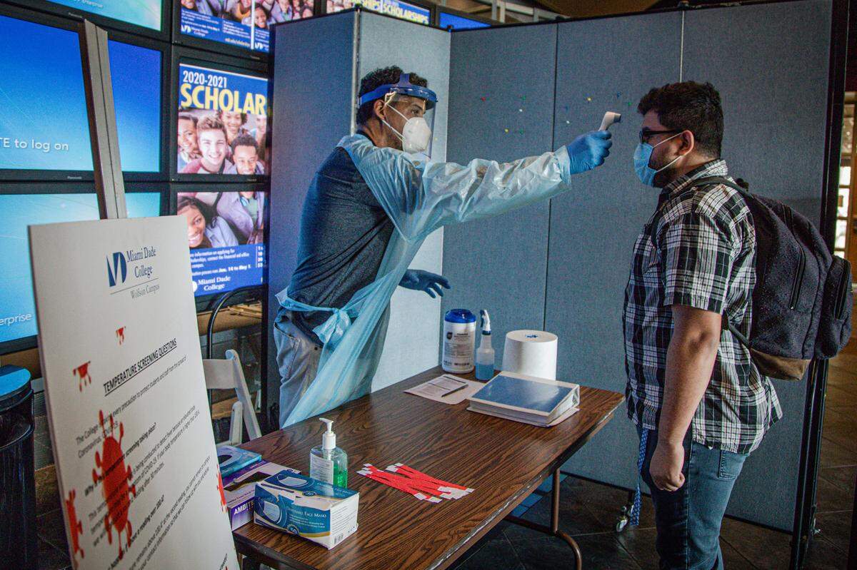 MDC students and staff get their temperature checked when they arrive at the Wolfson Campus checkpoint on June 23, 2020.