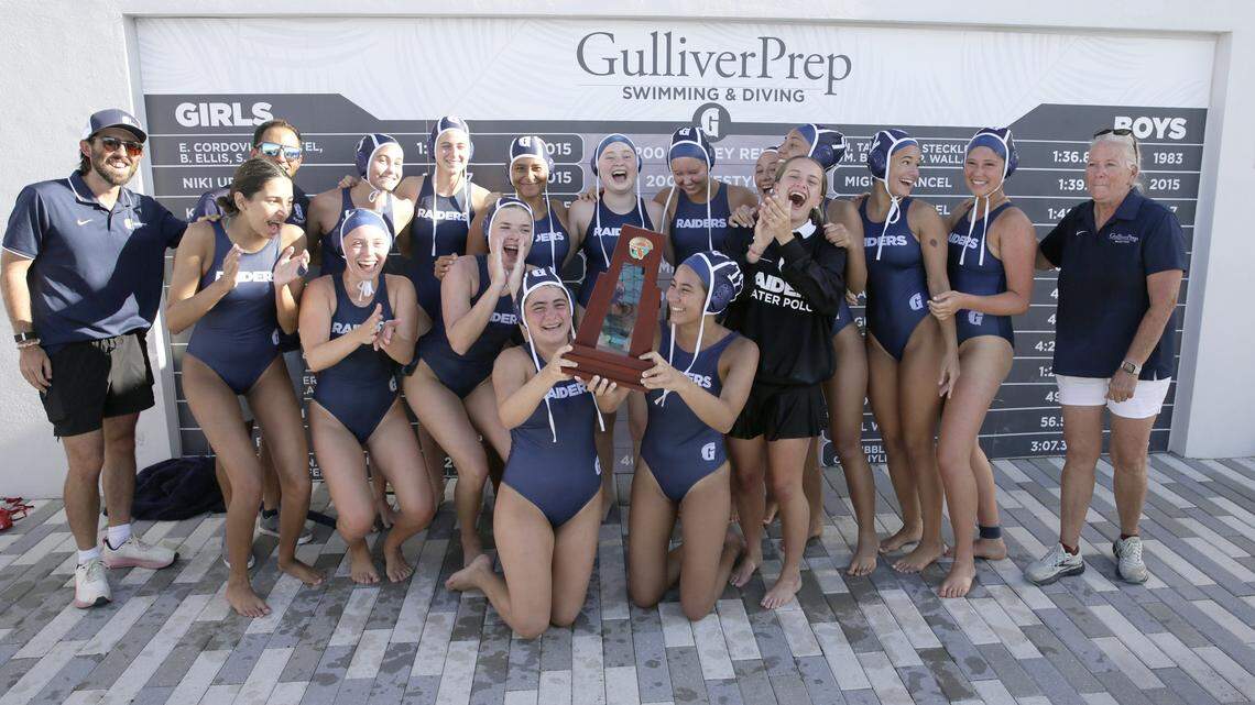 Gulliver Prep Riders pose with the trophy after winning regional girls' water polo final game against Ransom Everglades Raiders on Thursday, April 16, 2026 at Gulliver Prep HS in Miami. Andrew Uloza / for Miami Herald
