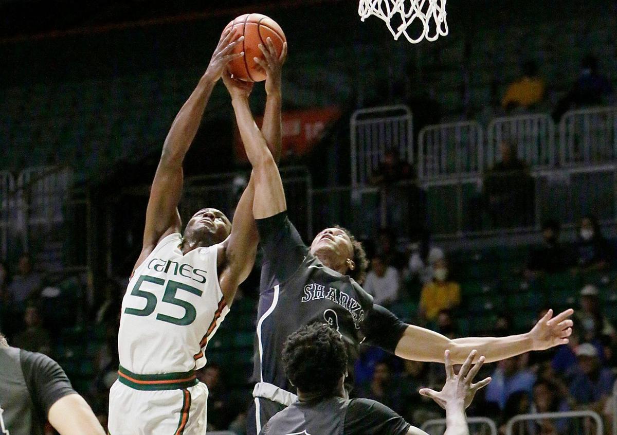 UM Hurricane Wooga Poplar (55) battles for a rebound during basketball game against Nova Southeastern Sharks on Wednesday, October 20, 2021 at Watsco Center in Coral Gables