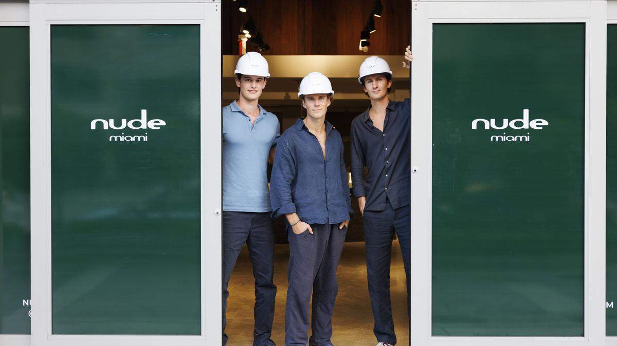 Sebastian Lezcano, left, Harry Miller, center, and Charles Amine pose during a photoshoot inside of what will be their grocery store on Tuesday, Jan. 6, 2026, at Nude Miami in Brickell. Three young founders with Miami ties open Nude Miami in Brickell to serve South Florida's health-conscious with organic groceries, glass-bottled juices, grab-and-go meals and wellness brands