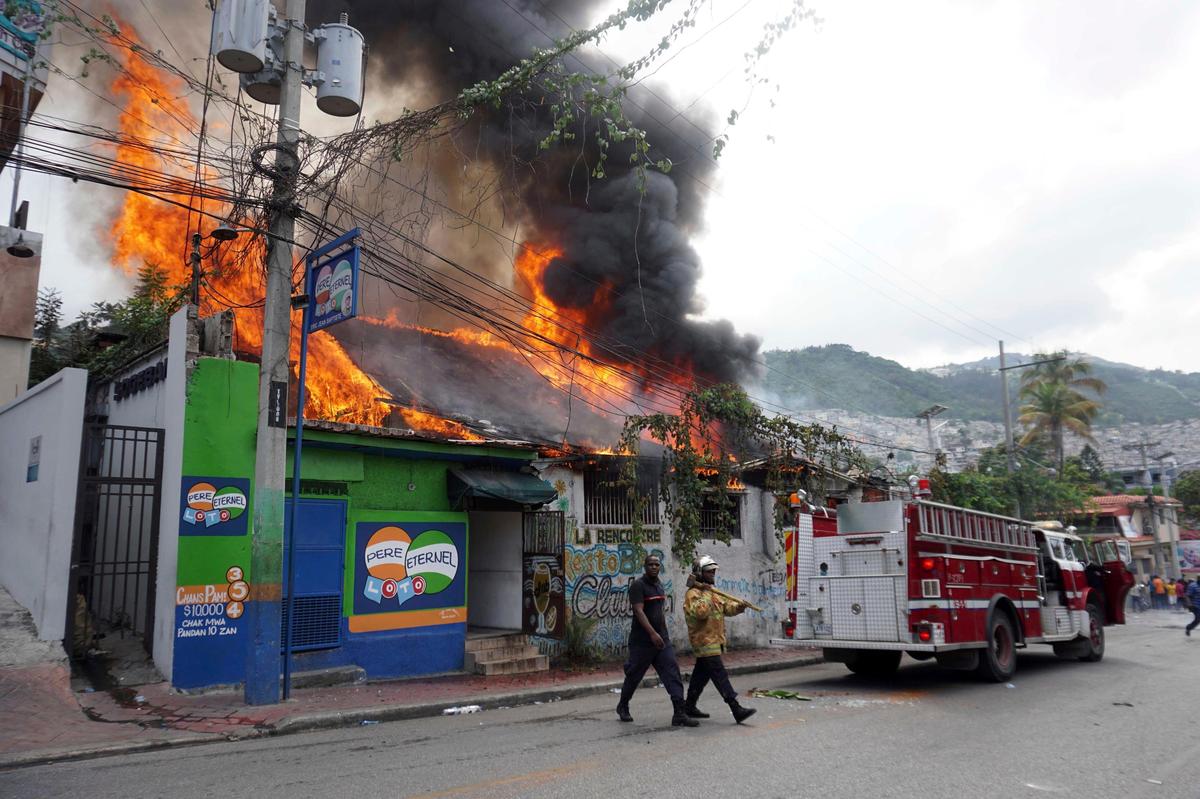 A building was set on fire by protesters in Port-au-Prince as thousands of protesters seeking to oust President Jovenel Moïse attacked businesses and government buildings across Haiti on Friday.