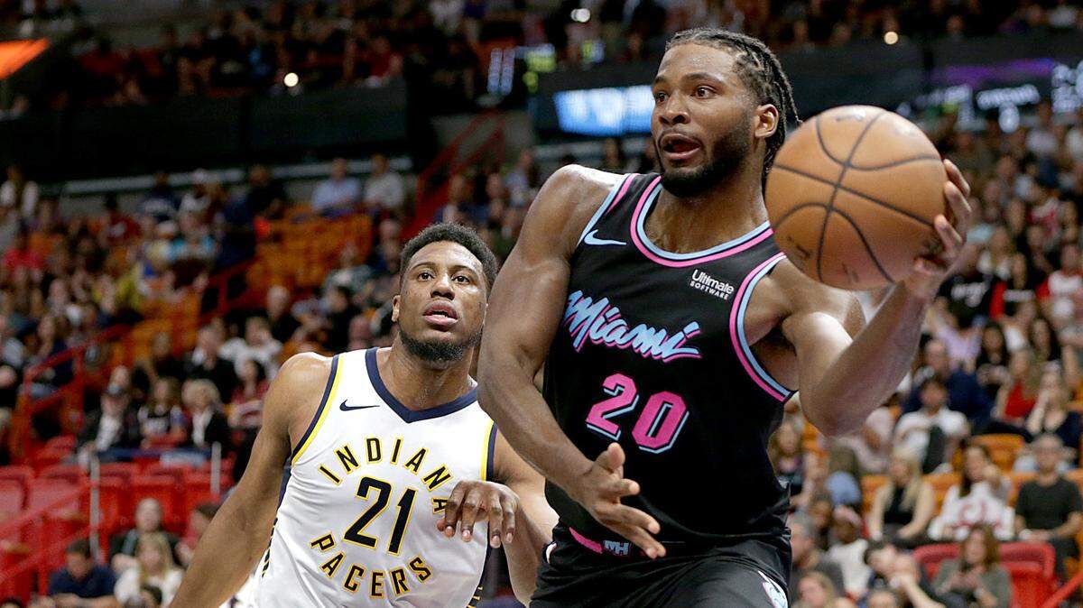 Heat forward Justise Winslow looks to make a pass ahead of Pacers forward Thaddeus Young, in the first quarter of the Miami Heat vs Indiana Pacers, at AmericanAirlines Arena in Miami on Friday, November 9, 2018.