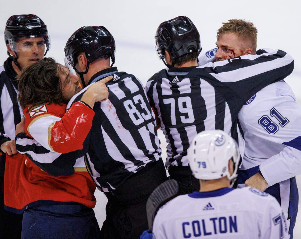Florida Panthers left wing Ryan Lomberg (94) and Tampa Bay Lightning defenseman Erik Cernak (81) grab at each other as officials trying to separate them during the third period of an NHL game at the FLA Live Arena on Sunday, April 24, 2022 in Sunrise, Fl.
