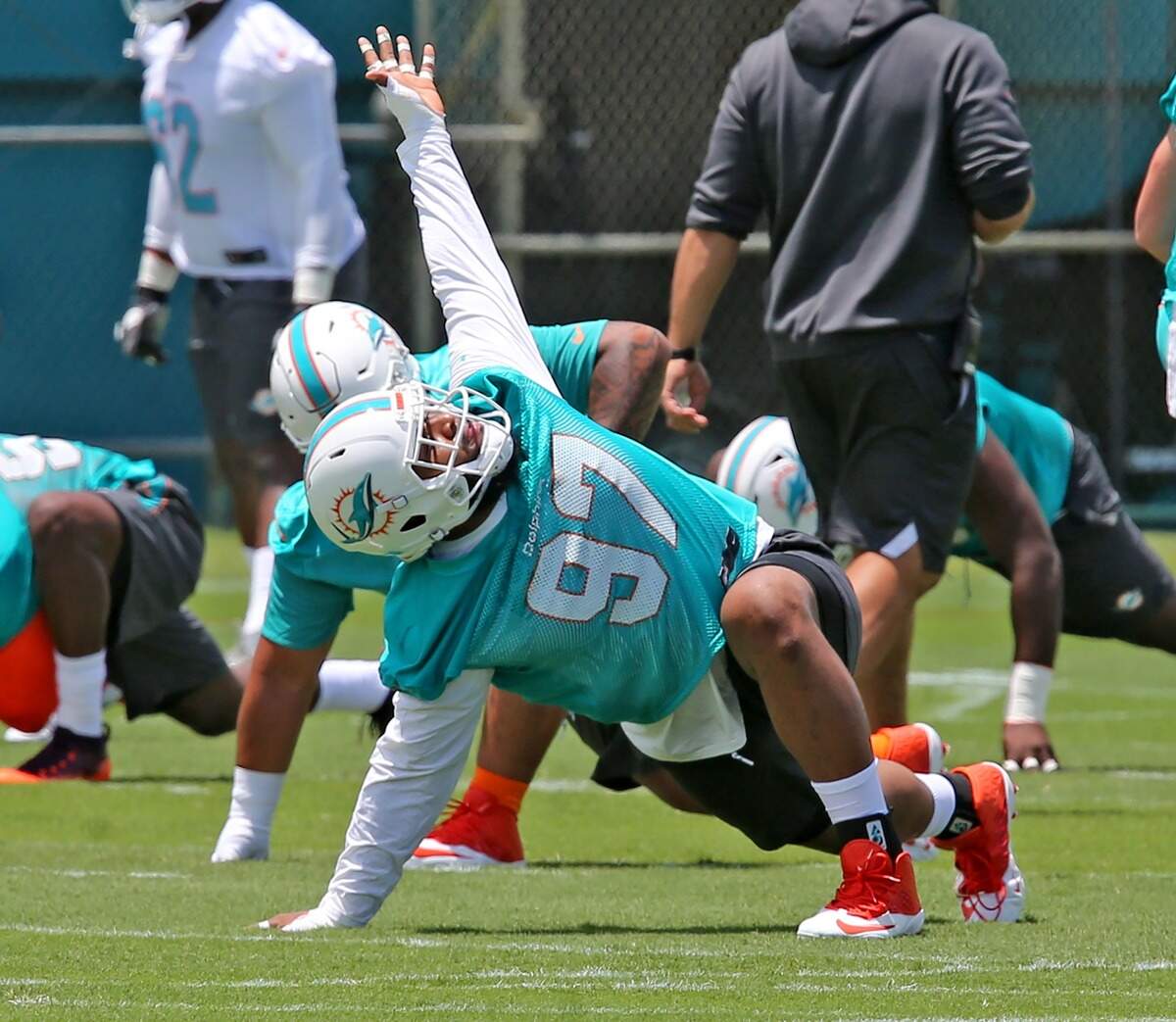 Miami Dolphins Christian Wilkins (97) warms-up at Rookie Minicamp at the Miami Dolphins training facility in Davie, Florida, Friday, May, 10, 2019.