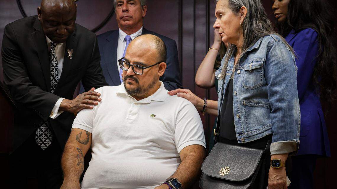 Michael Ortiz, center, finishes speaking while being supported by his mother, Betty Garcia, right, and Attorney Ben Crump, left, during a press conference discussing his case on Wednesday, March 1, 2023, at the Broward Law Office of the Public Defender in Fort Lauderdale. Ortiz was shot and paralyzed by Hollywood police in 2021 after he called 911 for help during a mental health emergency. “My mother has to take care of me like I’m a child and not a 40-year-old man,” said Ortiz.