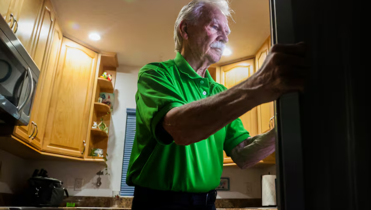 Larry Gesick packs his lunch before leaving for his job in the produce section at Publix. Larry and his wife, Joyce, are part of a wave of seniors working jobs past retirement age to keep up with rising prices.