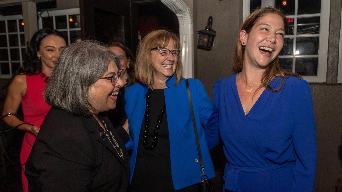 Sabina Covo, right, the winner of the District 2 special election in the city of Miami celebrates along with Miami Dade County Commissioner Eileen Higgins, center, and Miami Dade County Mayor Daniella Levine Cava during an election party on Monday, Feb. 27, 2023, at The Taurus in Coconut Grove.