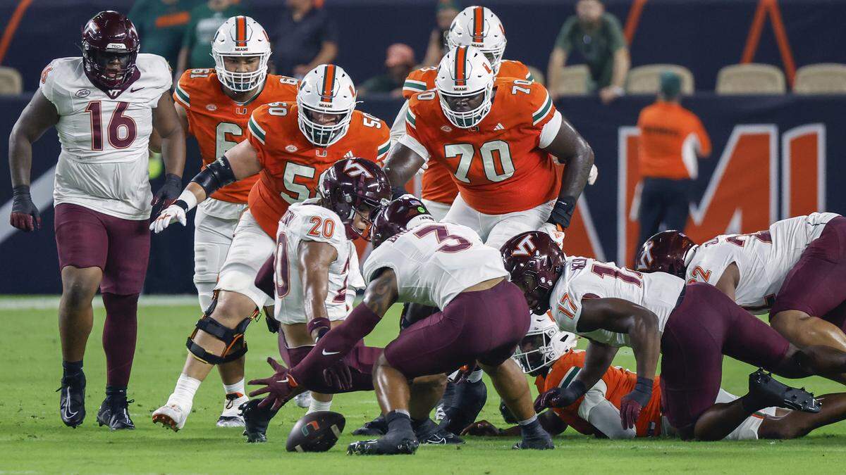 Miami Hurricanes quarterback Cam Ward (1) loses the ball as he gets sacked as Virginia Tech Hokies linebacker Sam Brumfield (3) recovers the ball during the first half of an ACC conference football game at Hard Rock Stadium on Friday, September 27, 2024, in Miami Gardens, Fla.