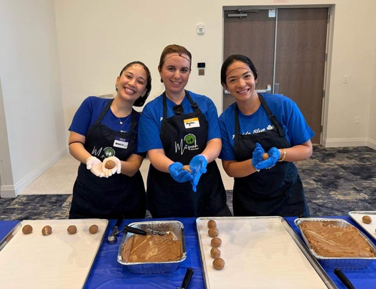 Veronica Marque, Alyssa Llerena, and Emperatriz Russian participate in a Florida Blue corporate day of volunteering at The Mitzvah Kitchen.