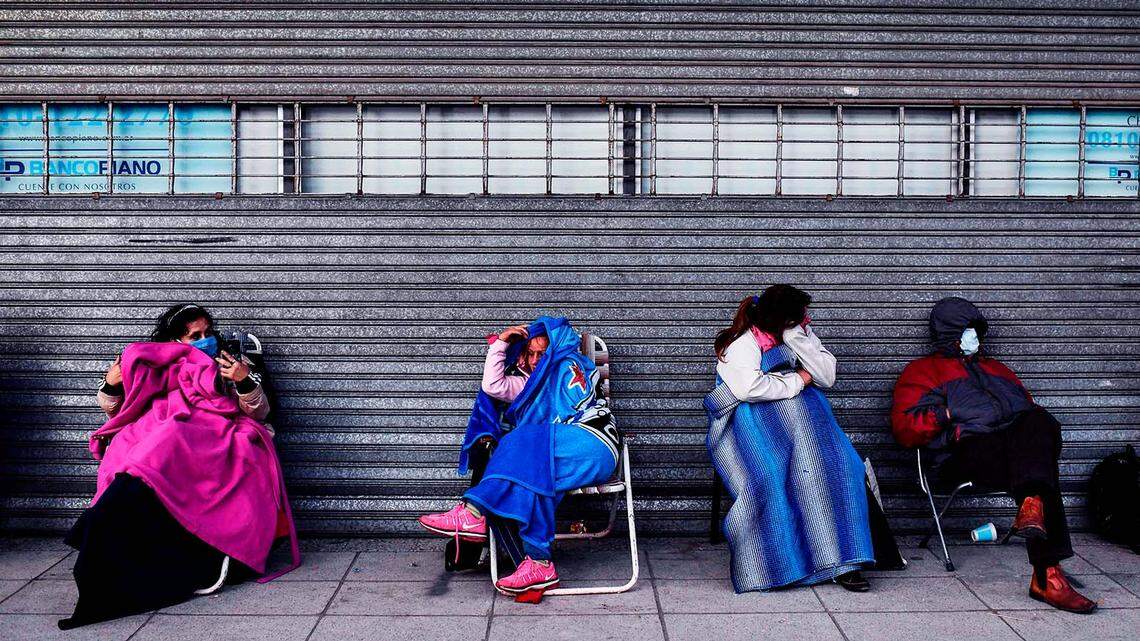 People line up outside a bank in Buenos Aires, Argentina, waiting to enter during special hours for retirees and social security beneficiaries.