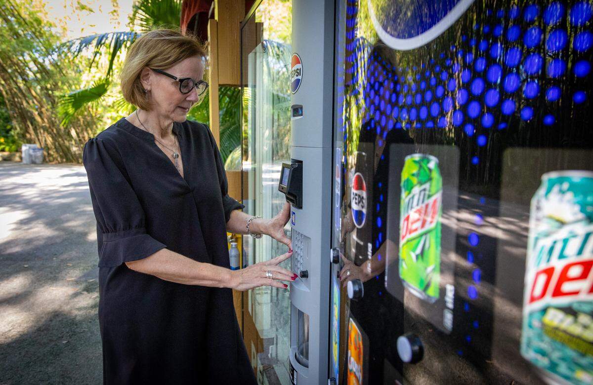 Eileen Higgins, District 5 Commissioner, uses vending machine with aluminum cans at Zoo Miami on Oct. 25.