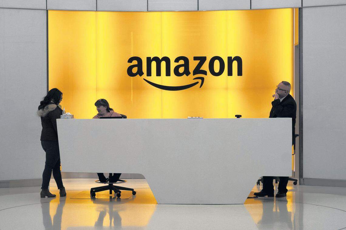 People stand in the lobby for Amazon offices in New York in February 2019. Online retailers like Amazon are leading to the decline in usual brick-and-mortar retail jobs, said economist Abbey Omodunbi.