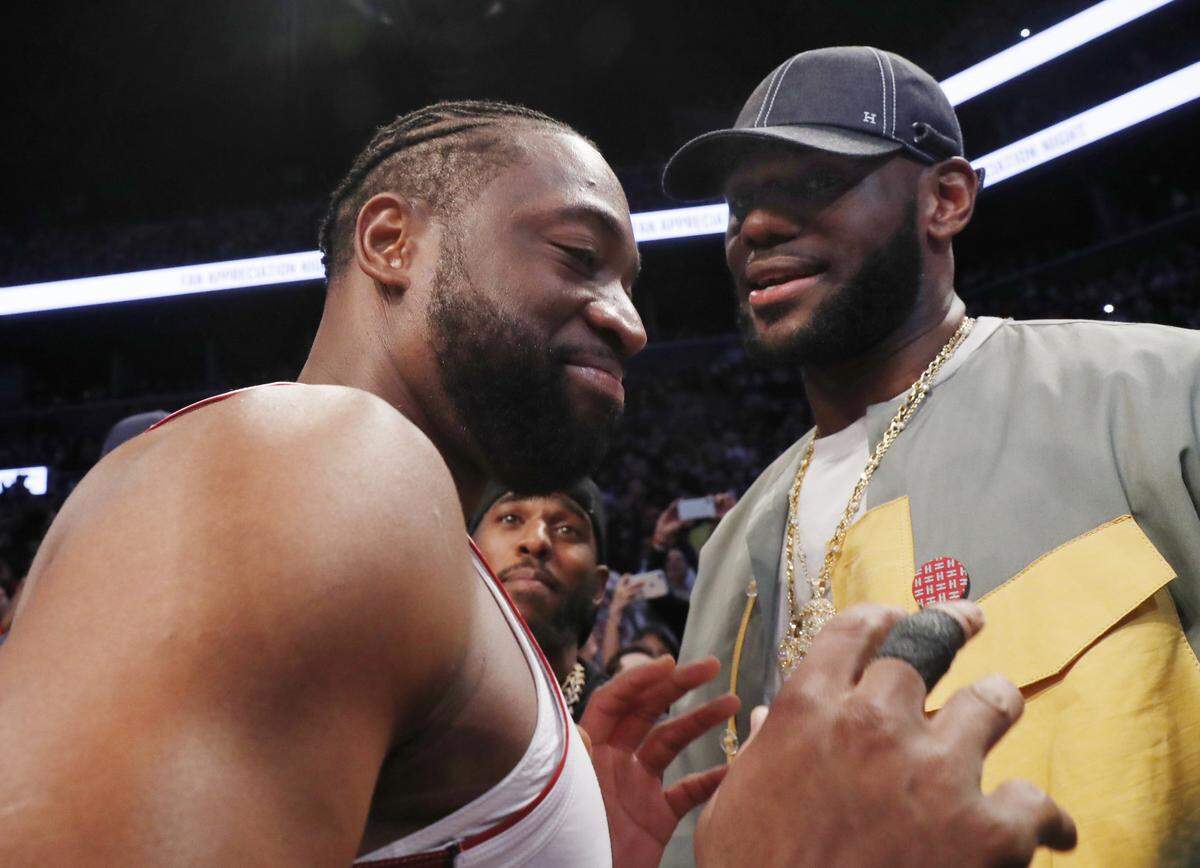 Miami Heat guard Dwyane Wade, left, chats with LeBron James before the Heat’s NBA basketball game against the Brooklyn Nets, Wednesday, April 10, 2019, in New York.