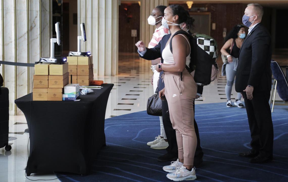 Miami Beach, Florida, June 1, 2020- Rebecca Colette, foreground, and Latoya Rucker, background, from Detroit, Michigan, have their temperatures checked in the main lobby of the Fontainebleau Miami Beach.