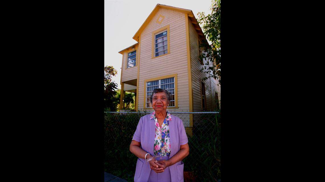 In 1996, Dr. Dazelle Simpson stands outside the home she grew up in on Charles Avenue in Coconut Grove.