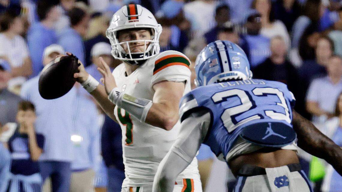 Miami quarterback Tyler Van Dyke (9) looks to pass over North Carolina linebacker Power Echols (23) during the first half an NCAA college football game Saturday, Oct. 14, 2023, in Chapel Hill, N.C. (AP Photo/Chris Seward)