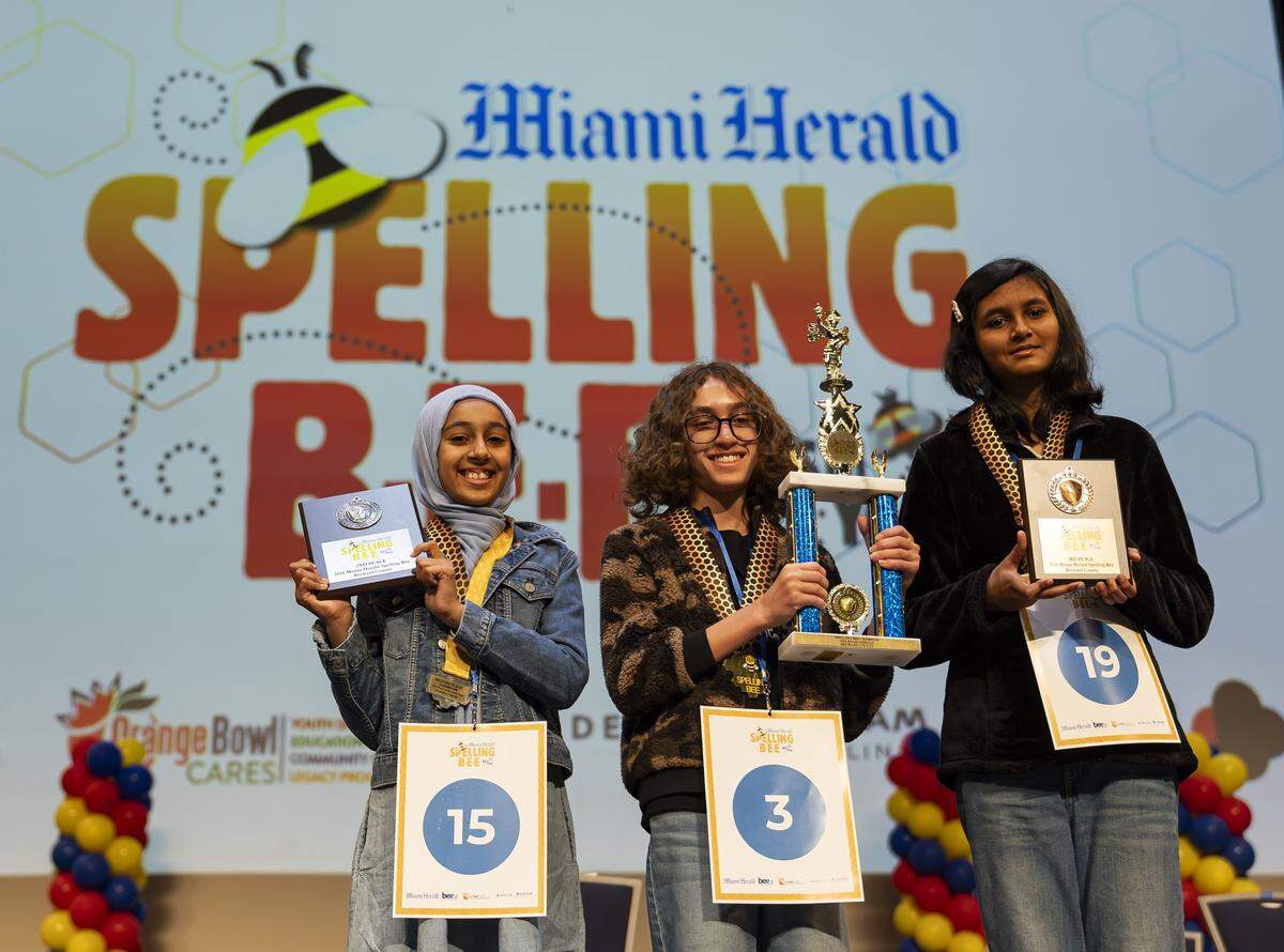 From left to right: Khadijah labal, Lancaster Gramer and Reya Rakesh gather for a photo after participating in the 86th Miami Herald Spelling Bee for Broward County at the Charles F. Dodge City Center on Wednesday, Feb. 25, 2026, in Pembroke Pines, Fla. Gramer won the competition after correctly spelling the winning word, californium.