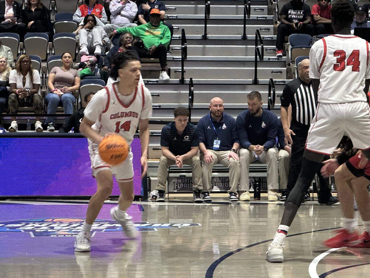 Columbus guard Felipe Quinones (left) gets ready to run a play during Friday’s Class 7A state semifinal against Lake Mary at UNF Arena in Jacksonville, Fla.