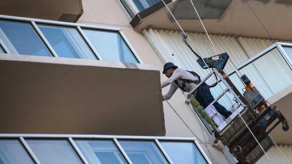 Workers do repairs on the exterior of the Mirage condo in Surfside, Florida, on Thursday, Oct. 7, 2021.