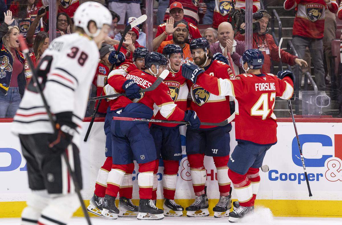 Florida Panthers center Jesper Boqvist (70) celebrates with his teammates after scoring against Chicago Blackhawks goaltender Spencer Knight (30) in the third period of their NHL game at Amerant Bank Arena on Tuesday, Oct. 7, 2025, in Sunrise, Fla.