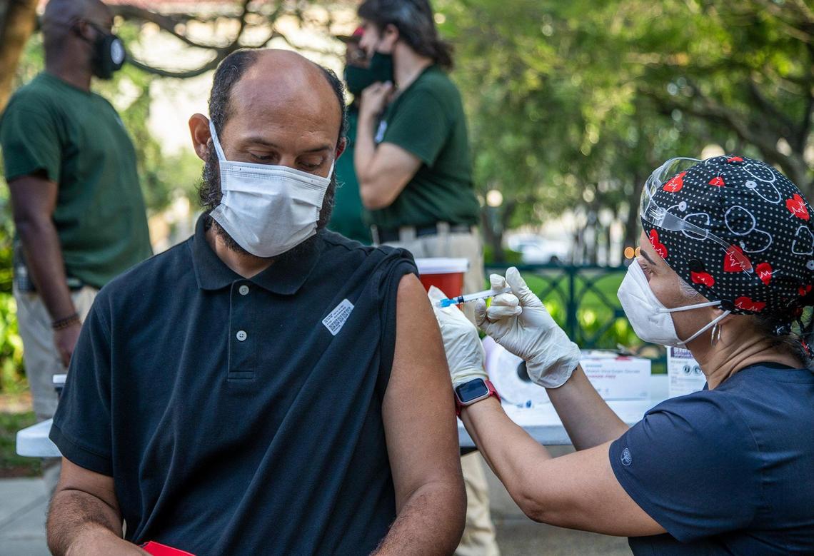 Uberne Vargas, a homeless man living in downtown Miami, gets a shot of the (J&J/Janssen) COVID-19 vaccine from Nurse Niurka Pérez as part of vaccination tours throughout unsheltered homeless hot spots and shelters across Miami-Dade to ensure the homeless have access to the vaccine.
