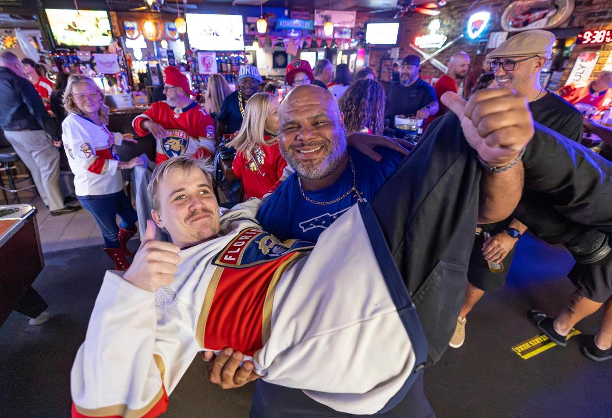 Florida Panthers fans Chris Miller, left, and Danny Rimmer celebrate after their team scored against the Edmonton Oilers in Game 2 of the NHL Stanley Cup Final at the Inn Field Bar & Grill on Friday, June 6, 2025, in Sunrise, Fla.