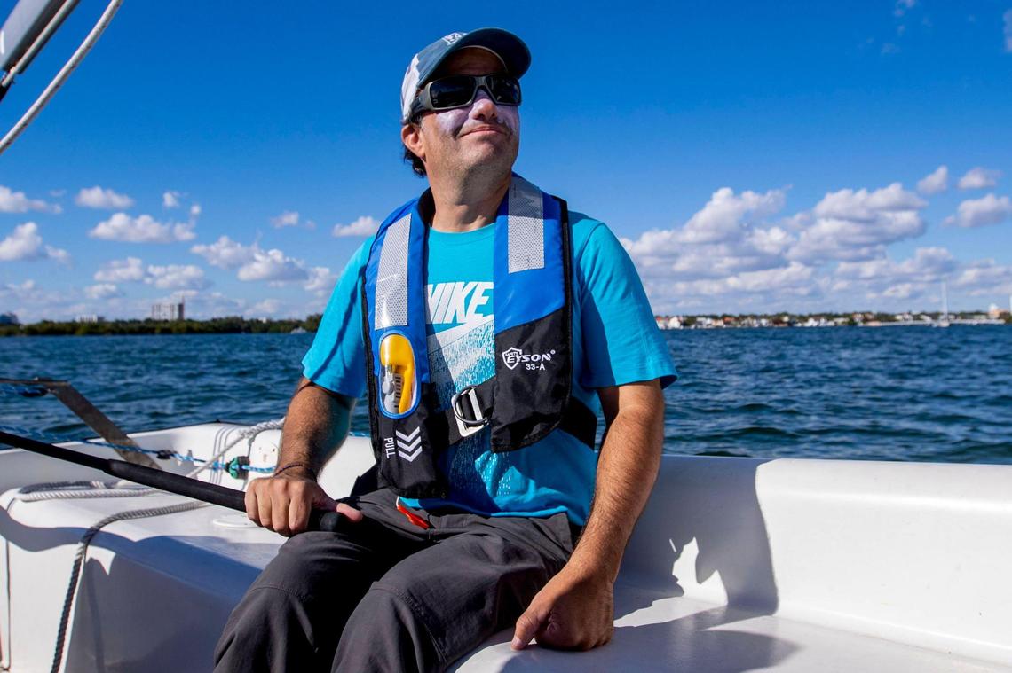 Argentinian psychologist Matias Paillot, 44, controls the tiller as he navigates the waters of Biscayne Bay, after launching from Shake-A-Leg Miami in Coconut Grove, on Jan. 12, 2023.